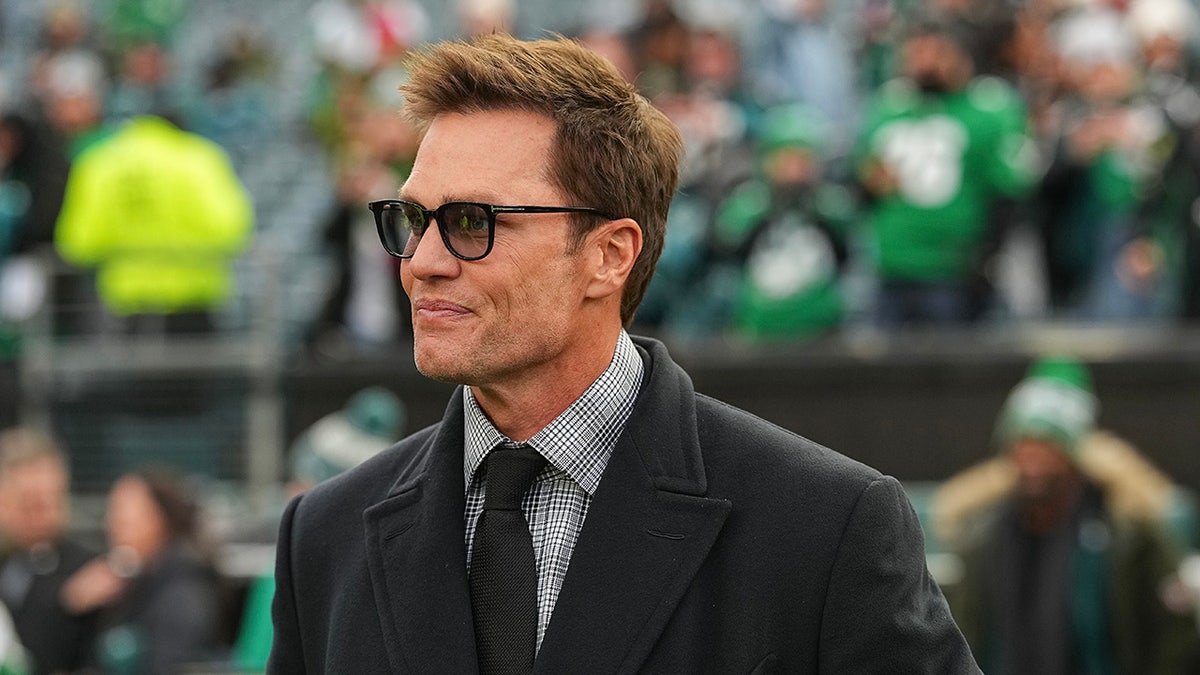 Tom Brady looks on before a game