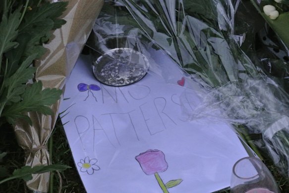 A note addressed to “Miss Paterson” lay among candles, toys, and flowers.