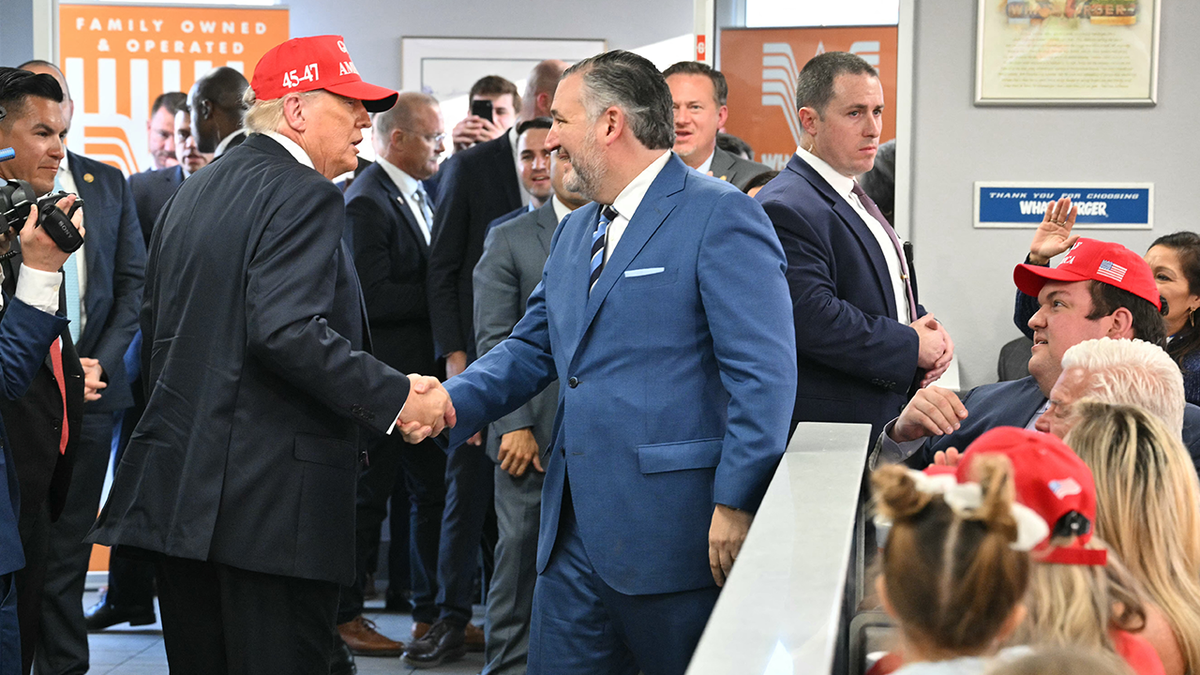 US President Donald Trump shakes hands with US Senator Ted Cruz (R-TX) in a Whataburger restaurant in Corpus Christi, Texas.