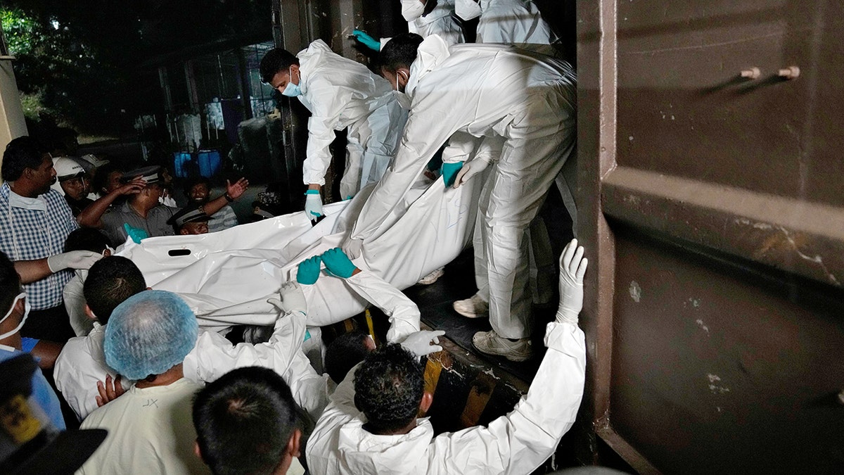 Healthcare workers unloading bodies