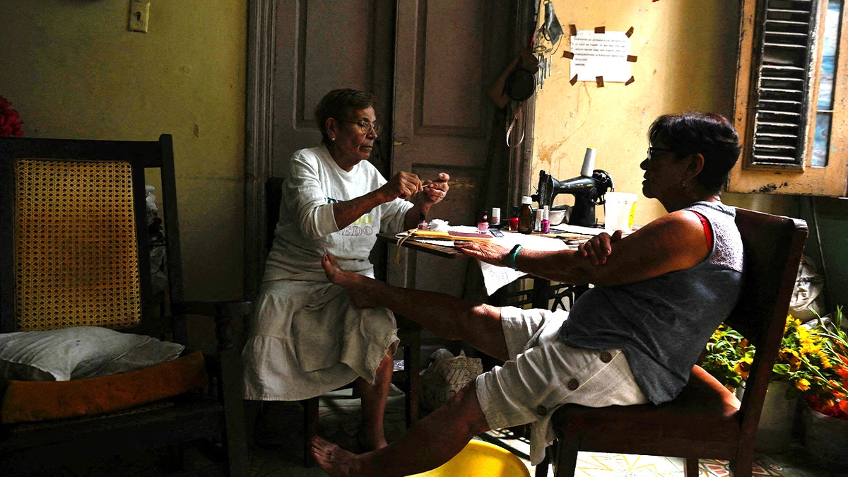 woman and man sitting at dining table in the dark
