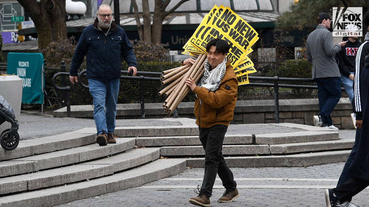 Members of the People's Forum Inc. setting up banners and signs in Union Square.