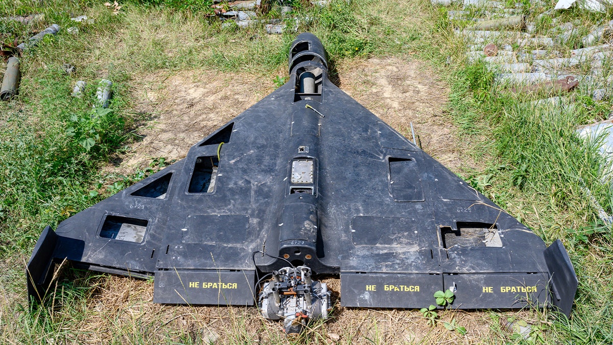 The wreckage of a Shahed-136 drone lies on display among other damaged weapons collected as evidence in Kharkiv.
