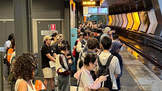 Commuters waiting at Chatswood station during the storm.