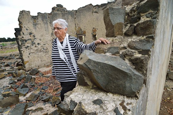 Laura Bell picks her way through the ruins at the Aboriginal Mission station, Lake Condah.