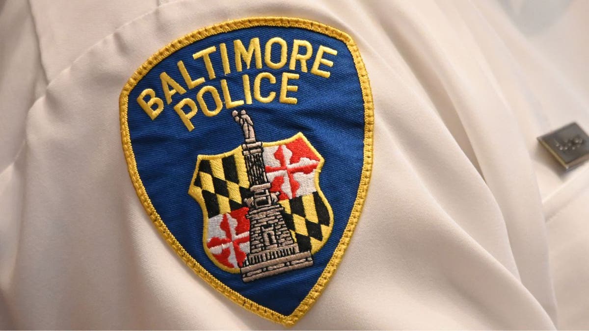 Close-up of a Baltimore Police Department patch on a uniform sleeve.