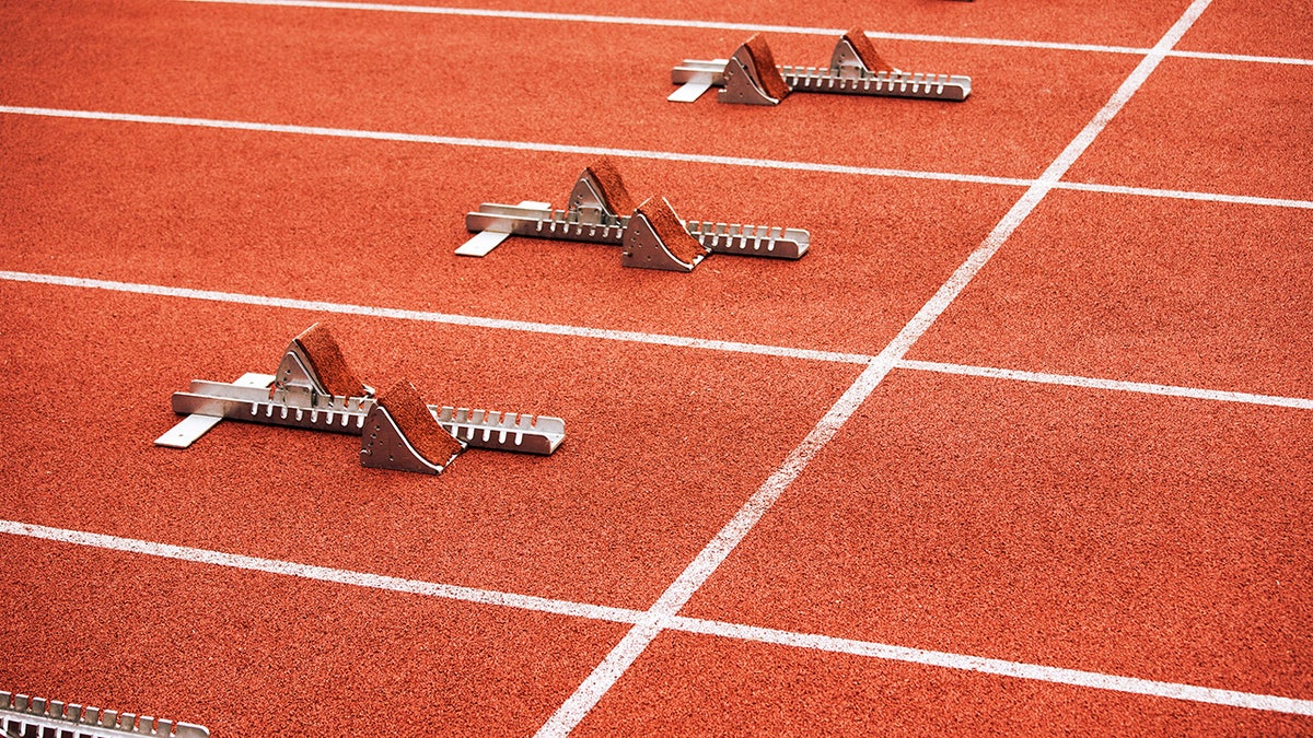 Five empty starting blocks on stadium