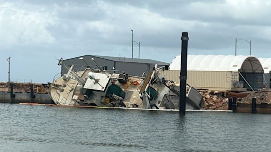 A vessel tipped on its side at Exmouth marina.