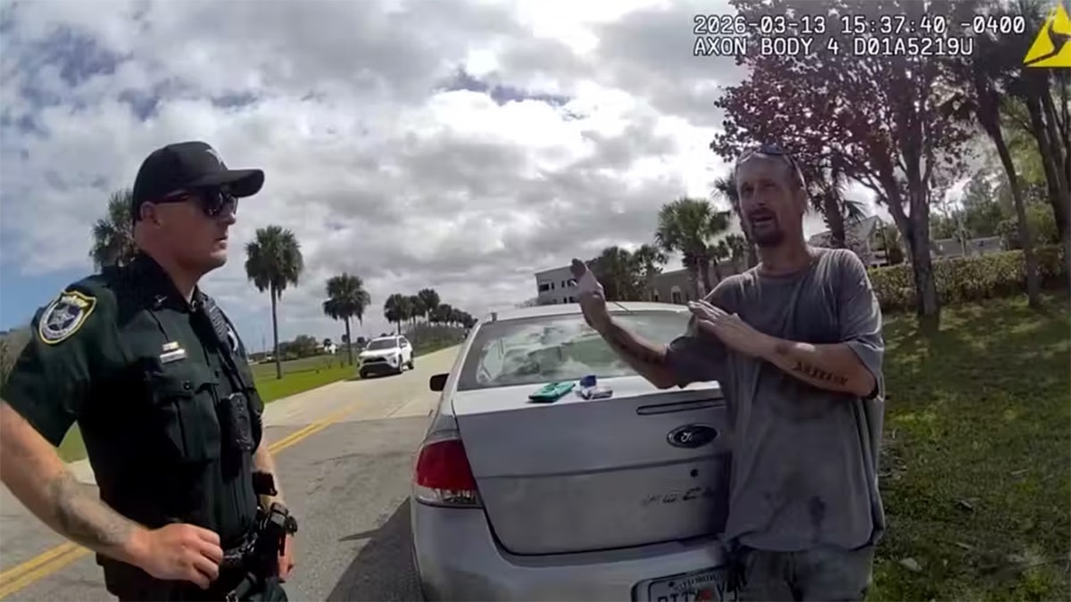 William Murphy III speaks with officer