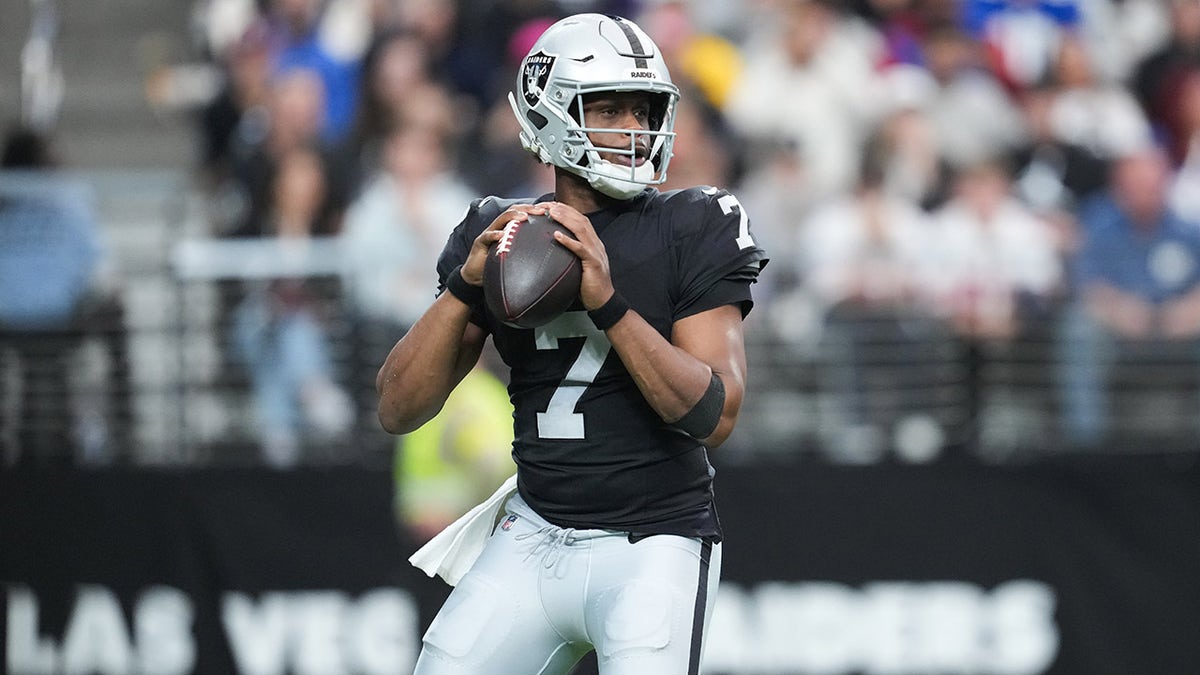 Geno Smith looks to throw a pass