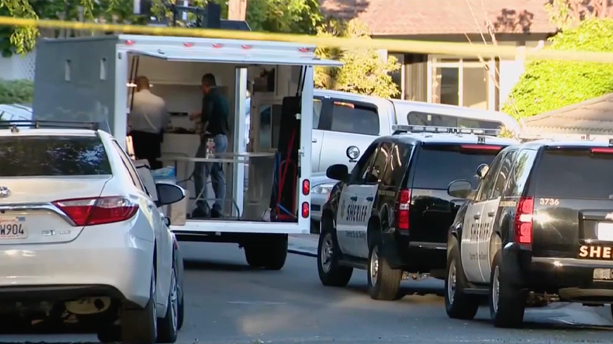 Detectives and crime lab personnel process the scene of a fatal stabbing in Lafayette