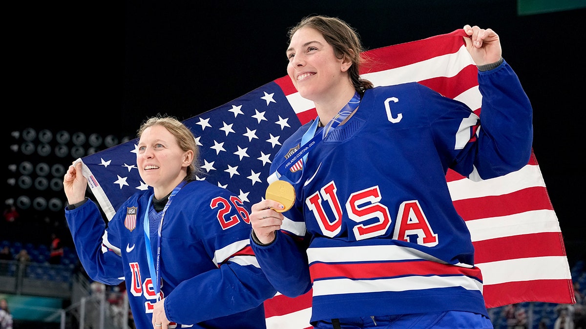 Kendall Coyne and Hilary Knight with flag