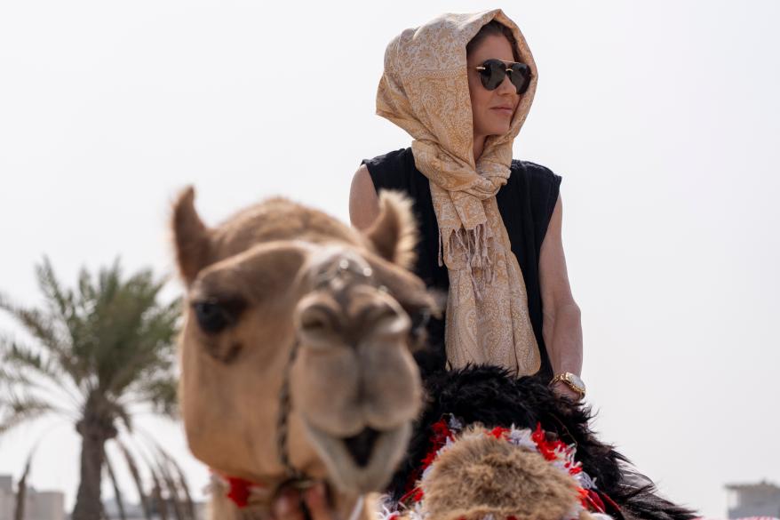 Noem riding a camel during a trip to Qal'at al-Bahrain Fort in Bahrain on May 25, 2025.