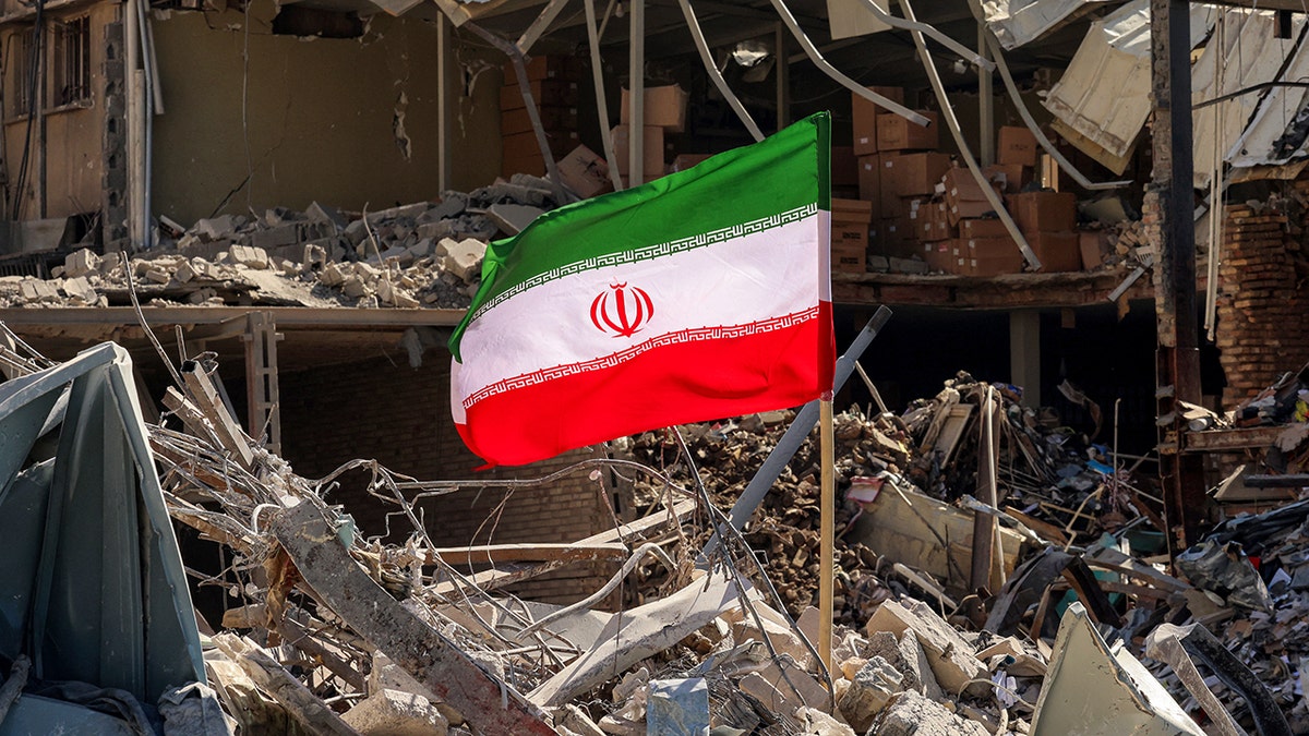 Iranian flag amid rubble