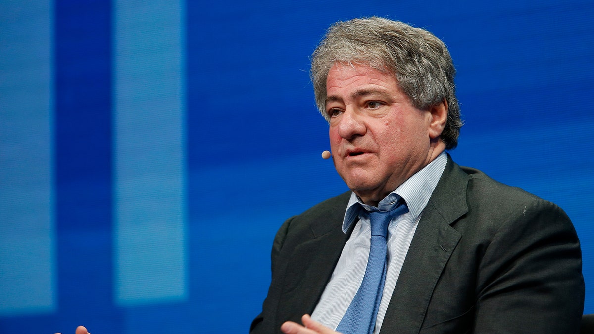 leon black wearing suit speaking during event 