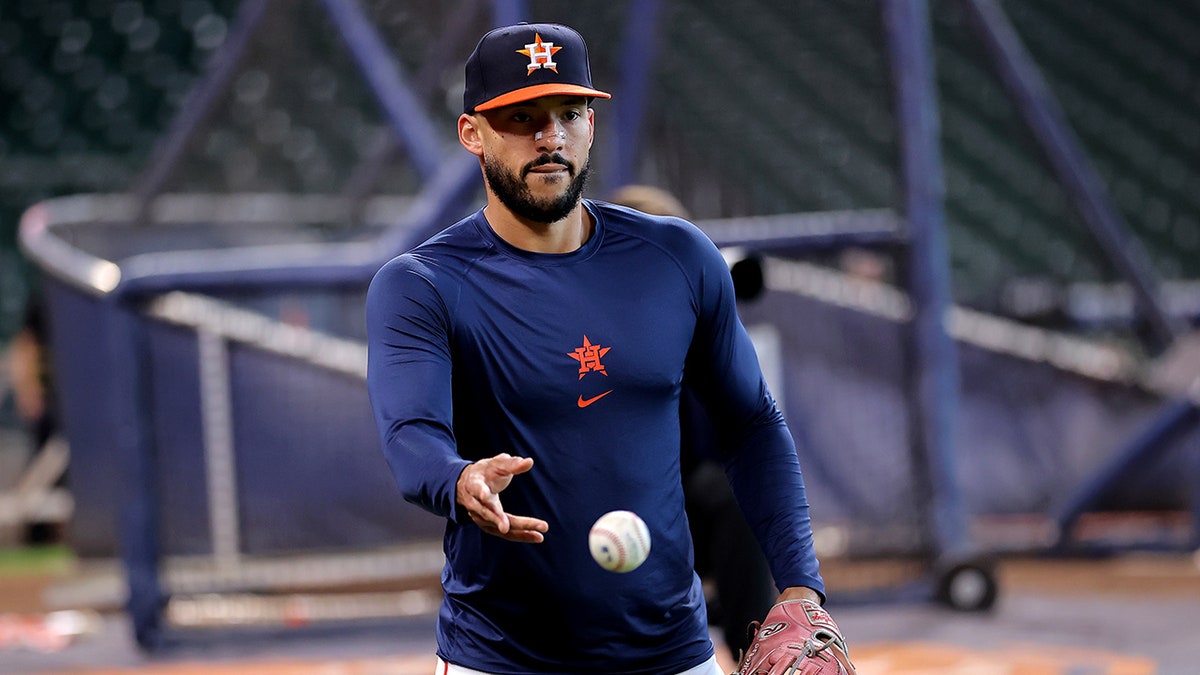 Carlos Correa tosses the ball