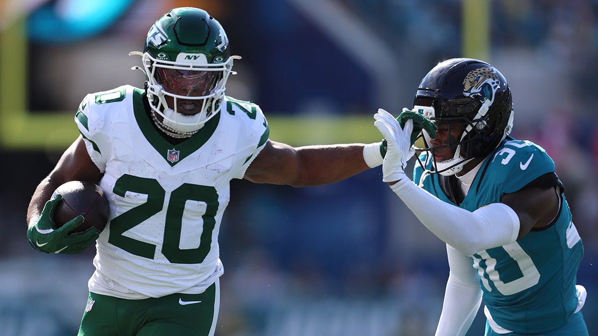 Breece Hall stiff arms a defender