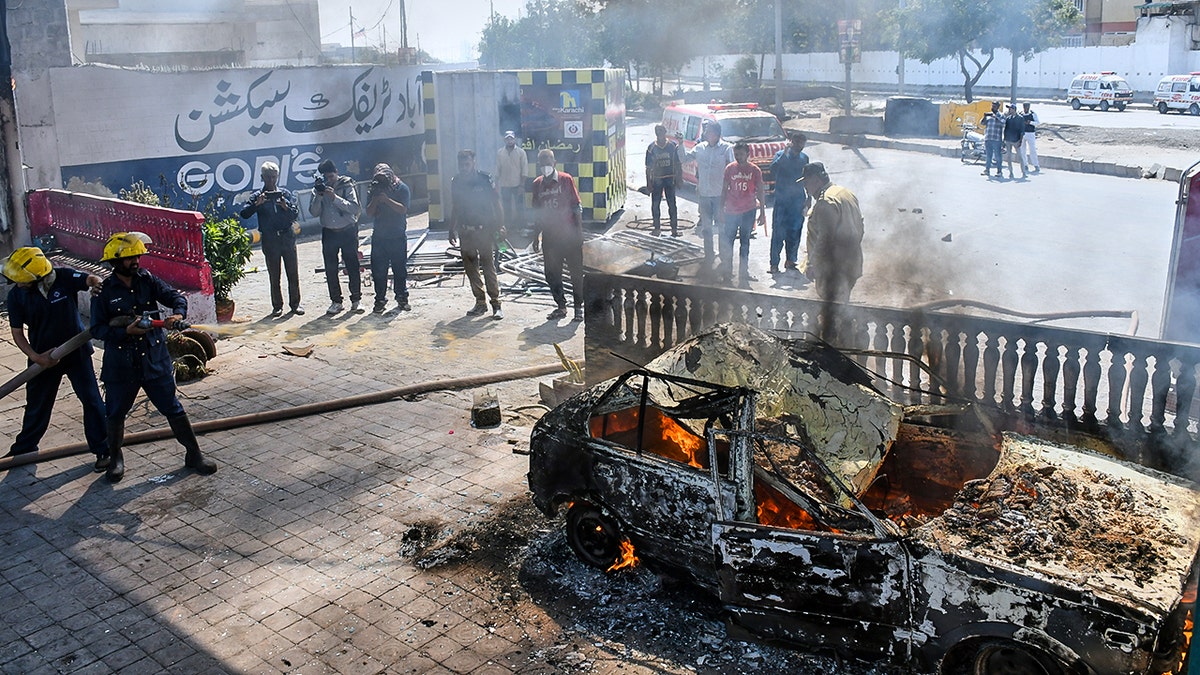 Protesters set a car ablaze in Pakistan.