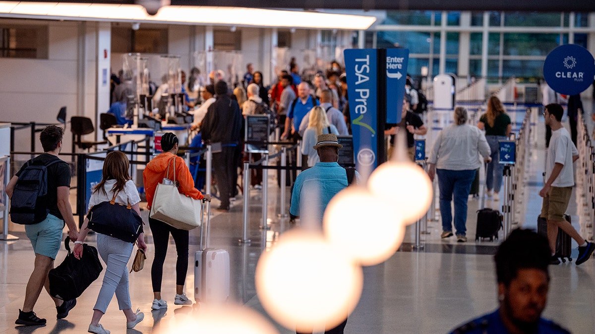 Passengers walk through a security checkpoint at Ronald Reagan Washington National airport.