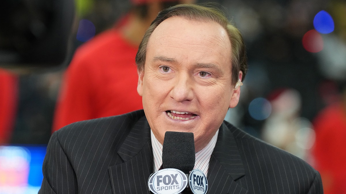 Tim Brando speaks into microphone