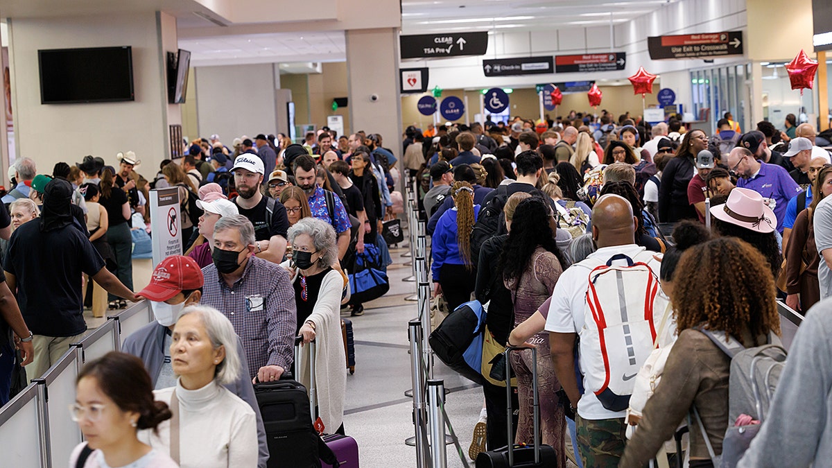 Airport passengers wait in an hours-long security line at William P. Hobby Airport in Houston, Texas, US, on Monday, March 9, 2026.