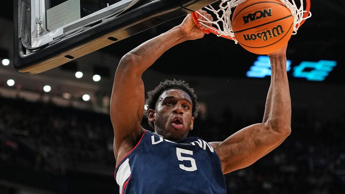 Tarris Reed Jr dunks the ball