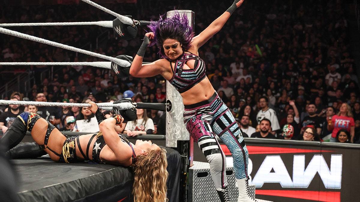 Bayley hits an elbow drop on Ivy Nile