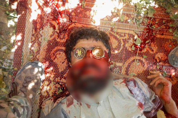 A dead Afghan with Australian coins placed on his eyes.