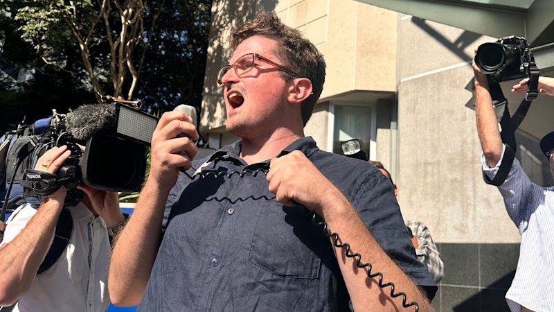 Protester twists banned phrase as crowd rallies for hate-speech accused Protester twists banned phrase as crowd rallies for hate-speech accused