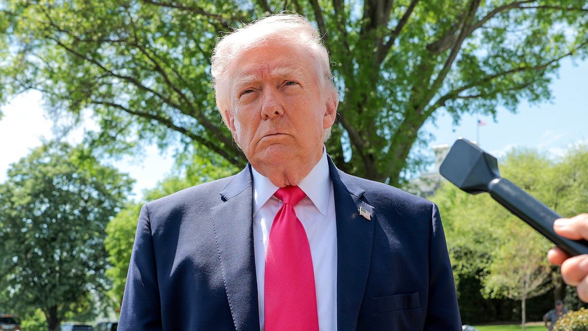 Trump speaks to reporters on White House South Lawn before boarding Marine One.