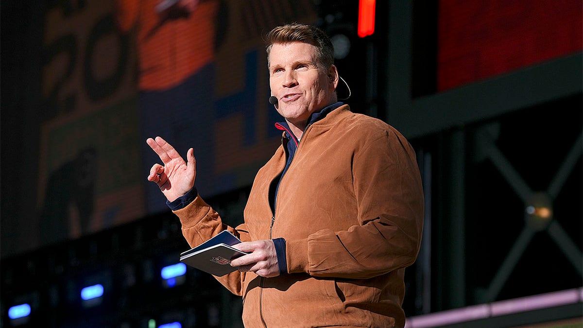 Scott Hanson speaking on stage at the 2025 NFL Draft in Green Bay Wisconsin
