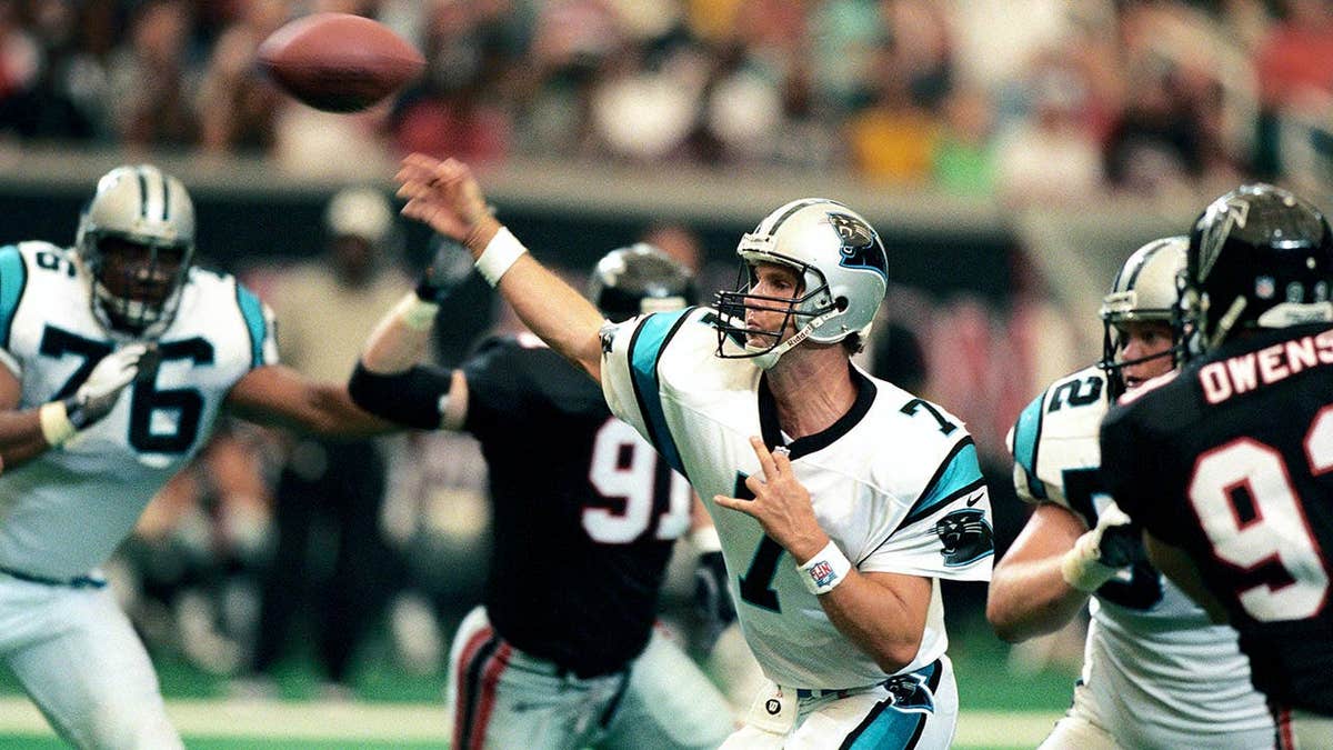 Steve Beuerlein throwing a football during a game against the Atlanta Falcons