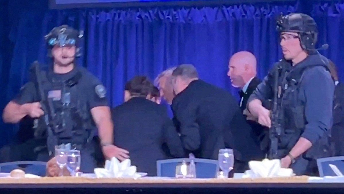 U.S. President Donald Trump being escorted out during White House Correspondents' Association Dinner.