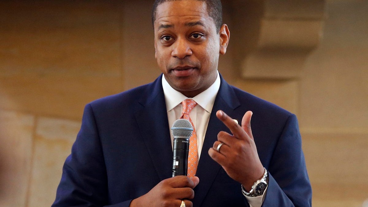 Then-Virginia Lt. Gov. Justin Fairfax gestures during remarks before a meeting of the Campaign to reduce evictions at a church meeting room in Richmond, Va.