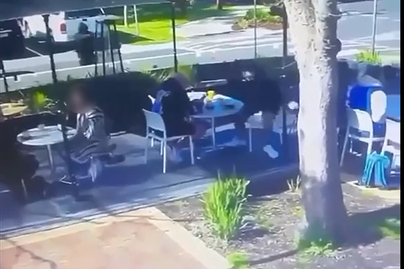 A still from CCTV footage shows a person dressed in dark clothing approaching Preston before the shooting.