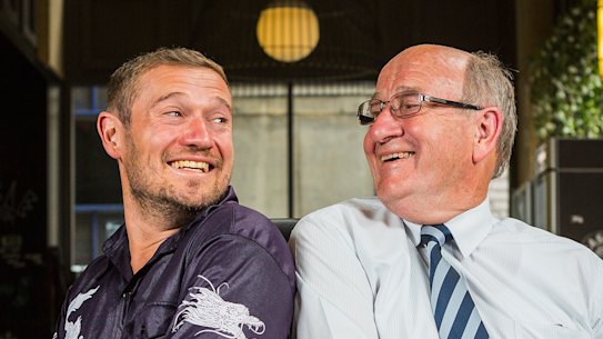 Simon Hughes and his father David Hughes posing for a photo in 2015.