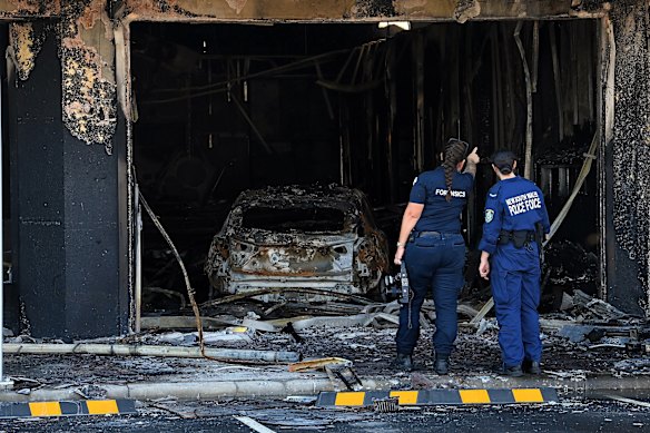 Forensic officers inspect the crime scene on Thursday morning. 