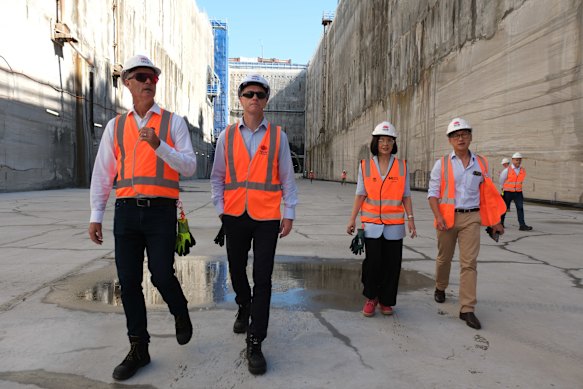 Transport Minister John Graham, left, Premier Chris Minns, Deputy Premier Prue Carr and Strathfield MP Jason Yat-Sen Li tour the Burwood North station site.