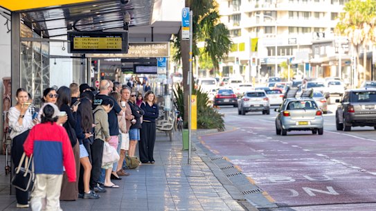 Commuters queue for a B-line bus at Dee Why on Monday morning.