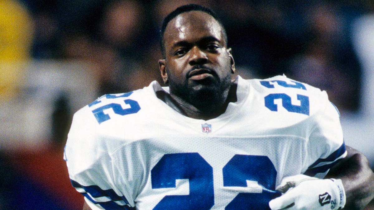 Emmitt Smith standing on the field in Dallas Cowboys uniform at the Georgia Dome