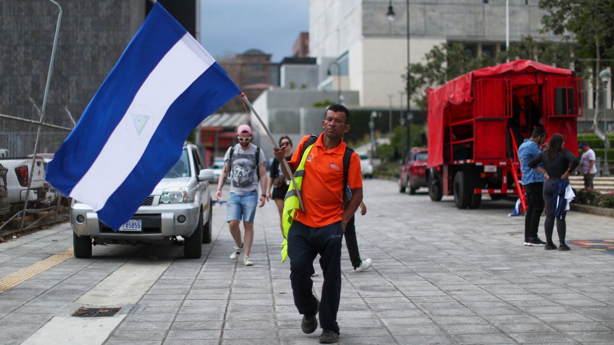 A man waving a Nicaraguan flag during a demonstration in San Jose, Costa Rica