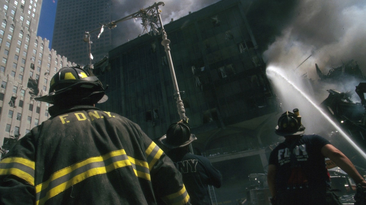 New York firefighter standing amid rubble at World Trade Center site