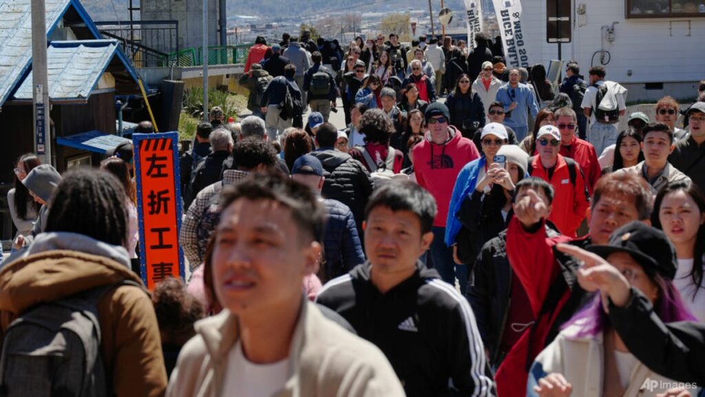 Japanese town sours on crowds coming to see cherry blossoms, Mount Fuji