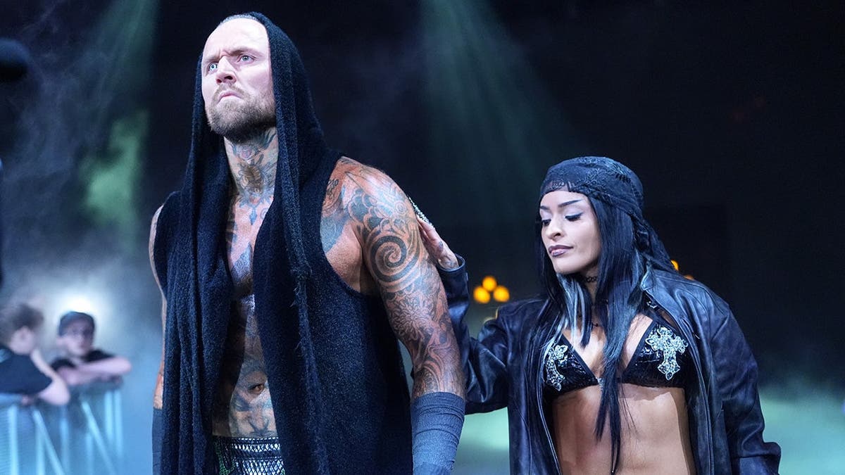 Aleister Black and Zelina Vega walking to the ring at Enterprise Center in St. Louis