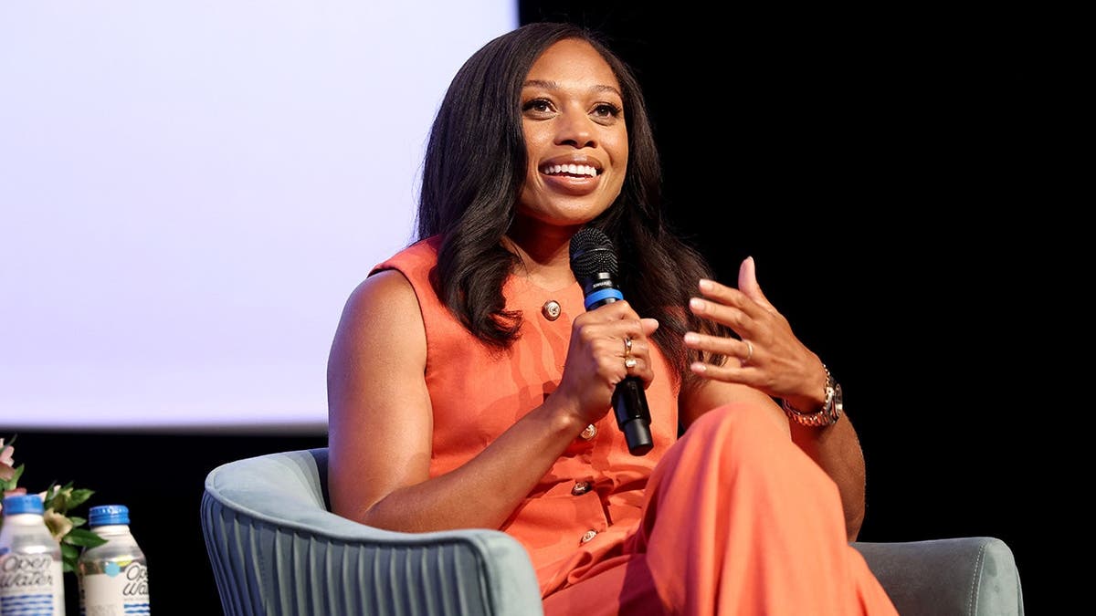 Allyson Felix speaking onstage at the Social Impact Summit in Los Angeles