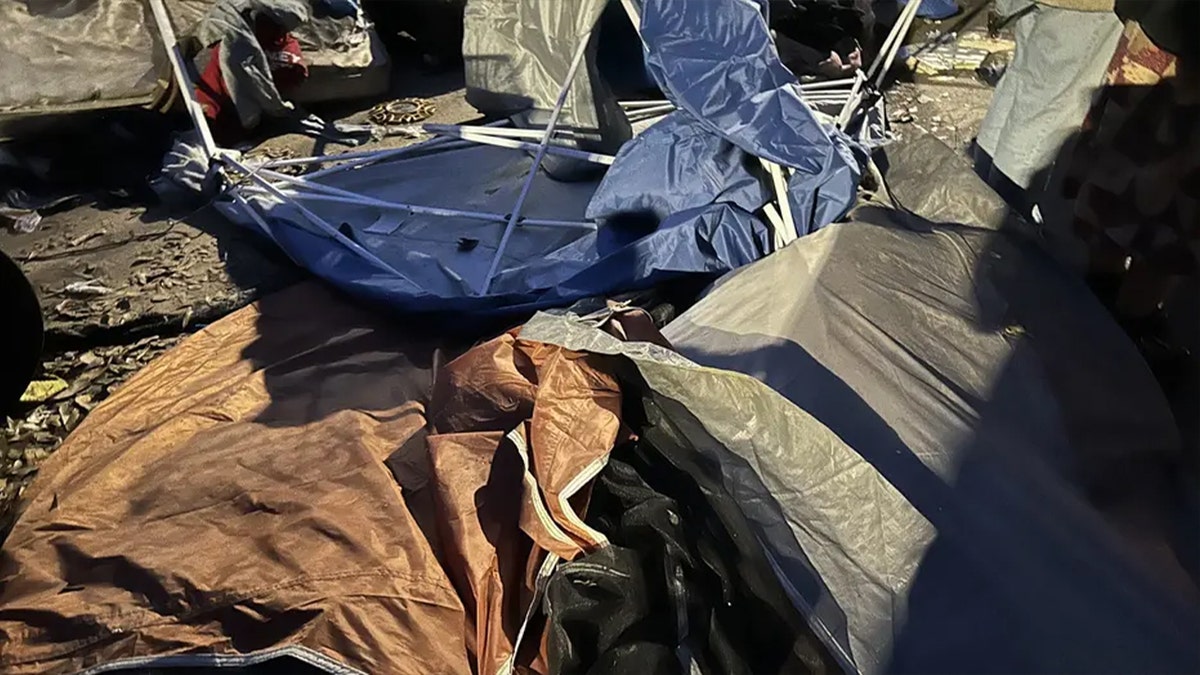 A man standing near a homeless encampment in Atlanta