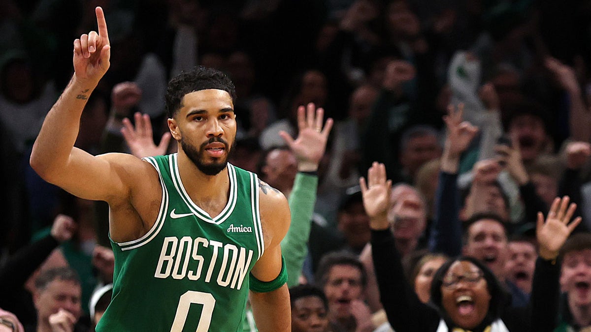 Jayson Tatum celebrating after scoring during a basketball game at TD Garden.