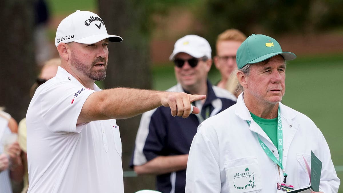 Brandon Holtz talking with his caddie Jeff Holtz during a practice round at Augusta National Golf Club