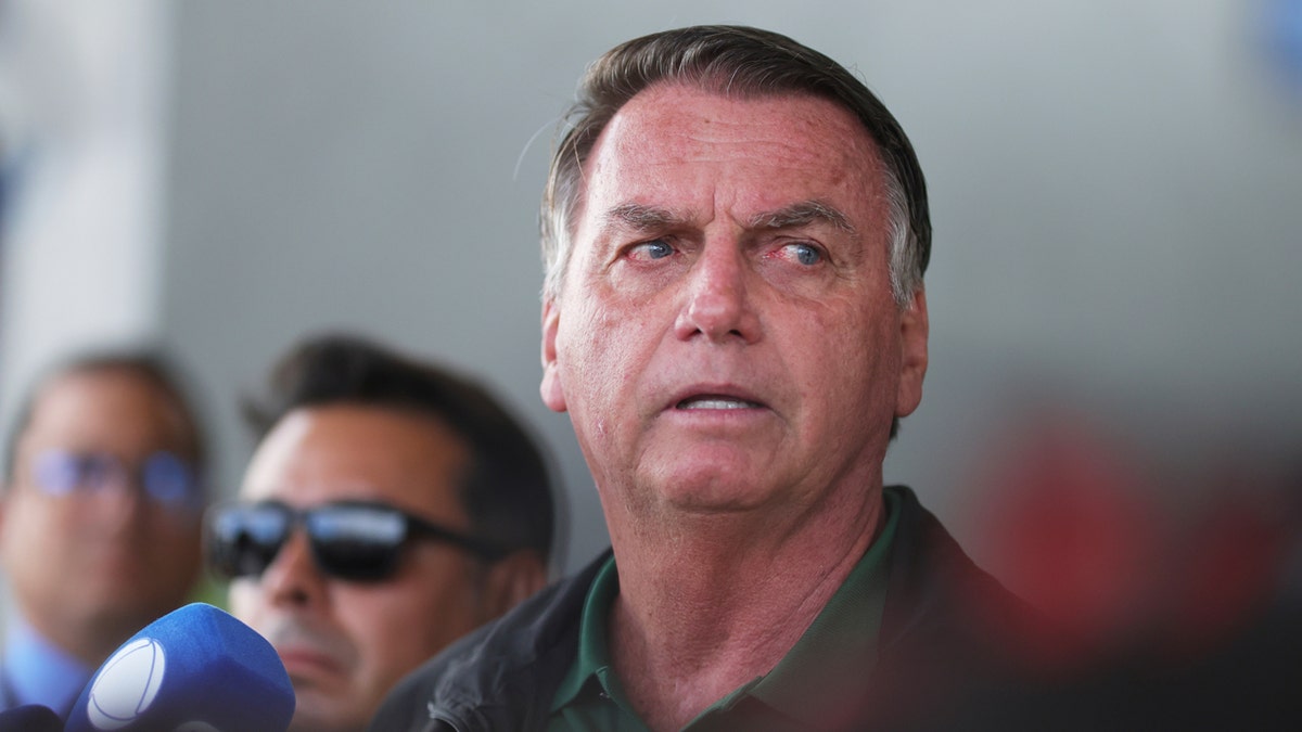 Former President Jair Bolsonaro speaking to the press at Brasilia International Airport