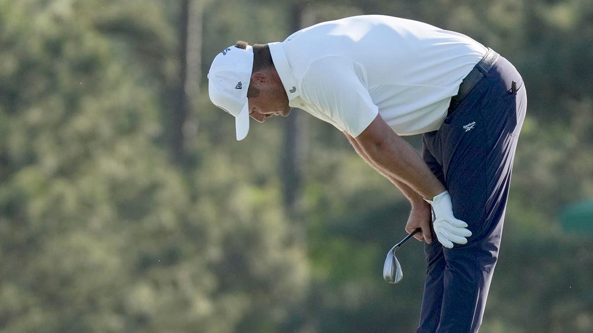 Bryson DeChambeau reacting on the 18th green at Augusta National Golf Club